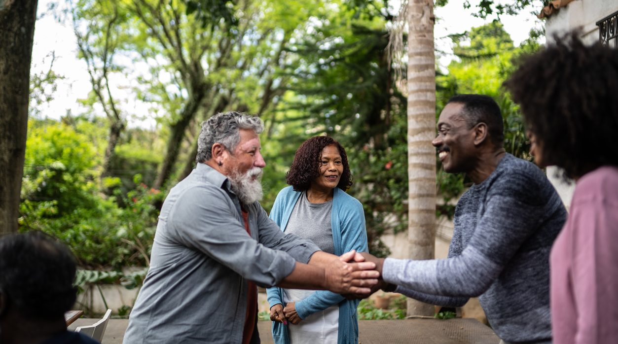 Neighbors greeting each other at front house