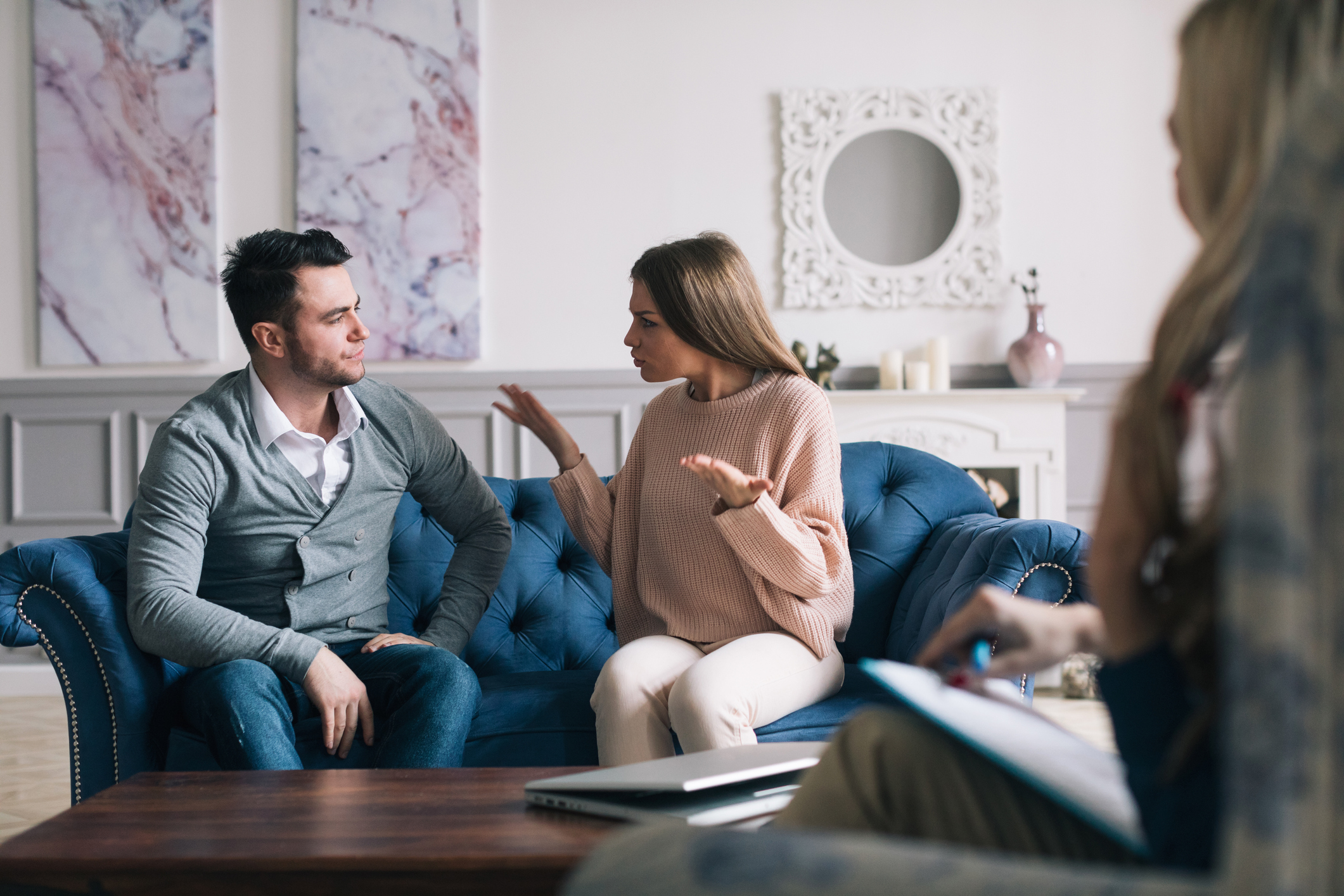 Couple visiting a psychologist and having a psychological session while dealing with problems in relationships