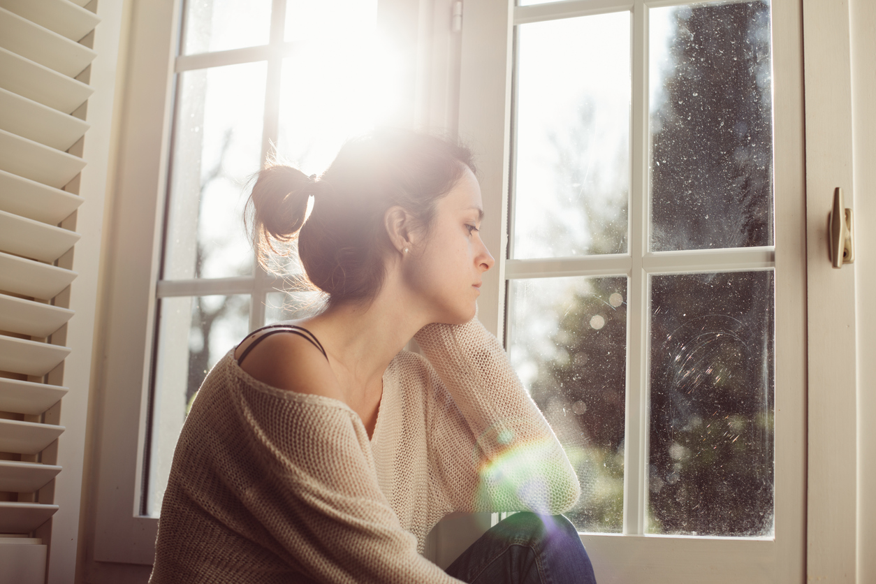 Unhappy wife sitting at the window