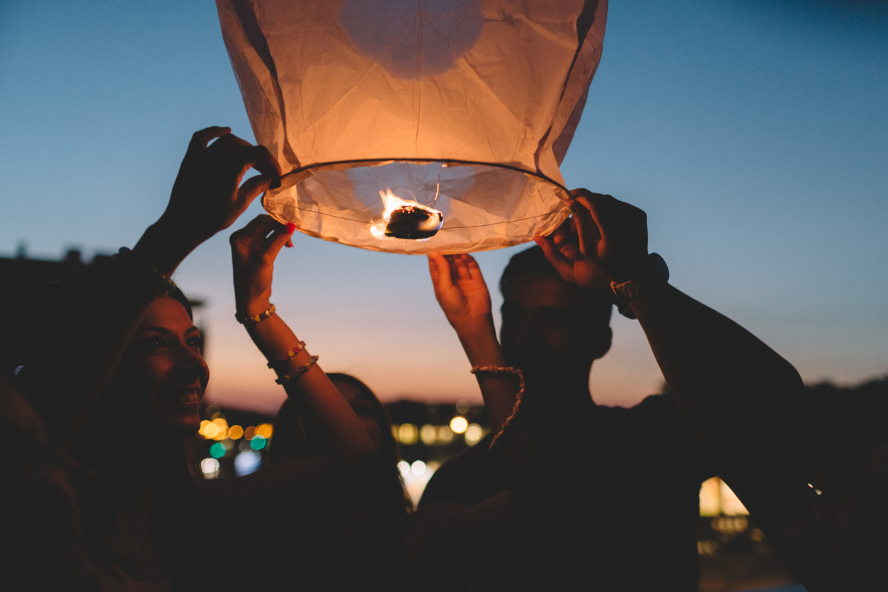 People releasing a flying lantern