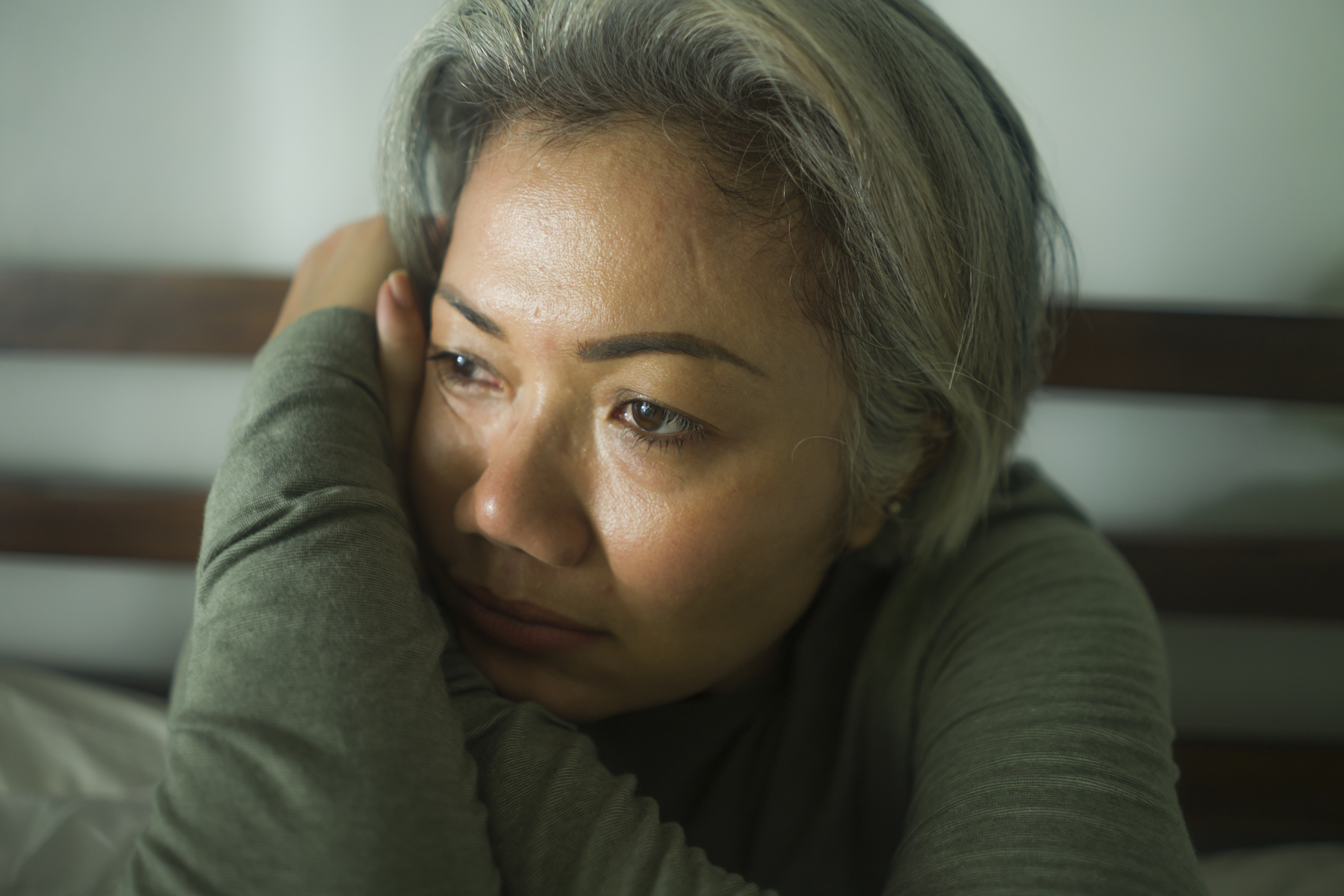 Mature middle aged woman with grey hair sad and depressed