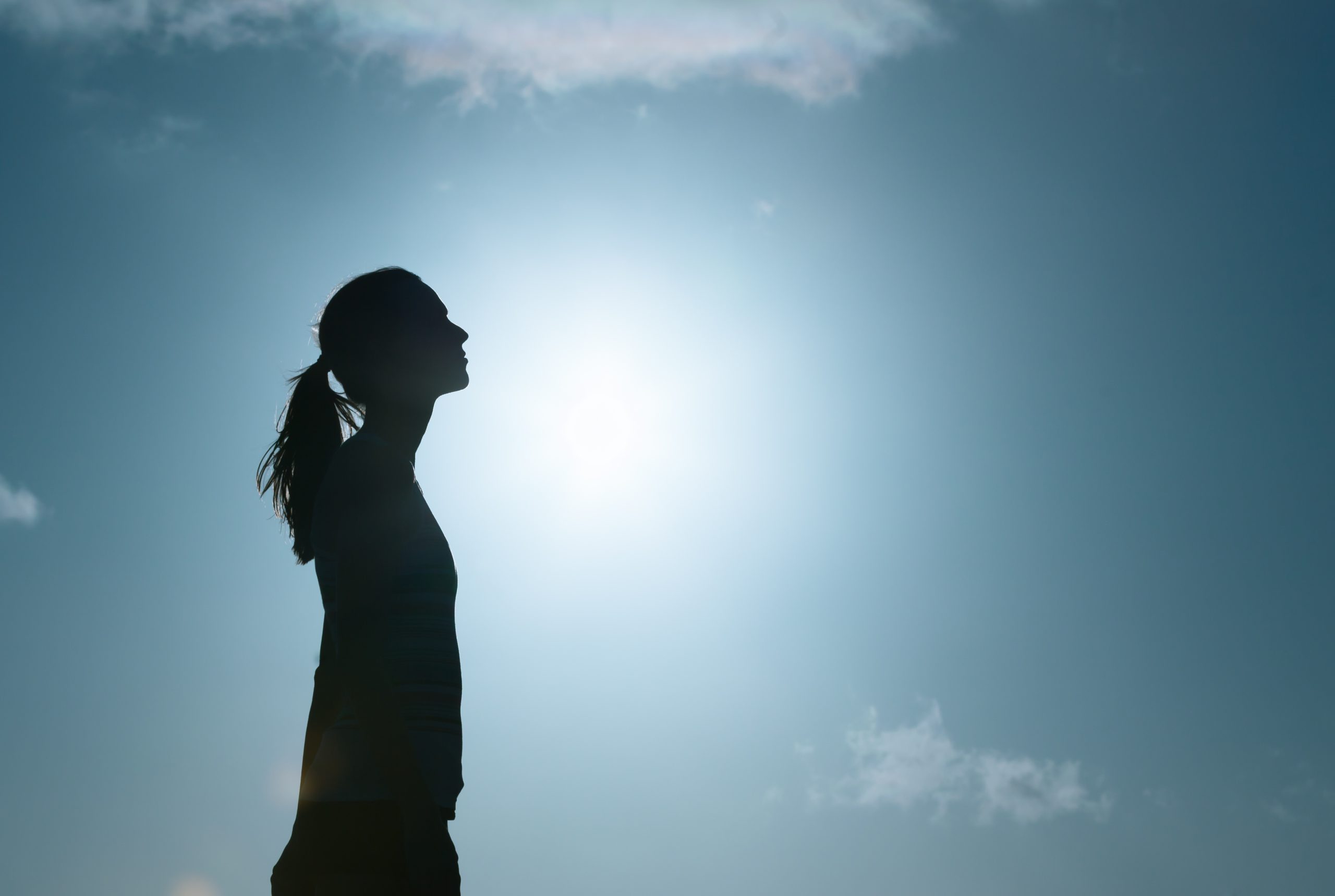 Young woman looking up into the sky