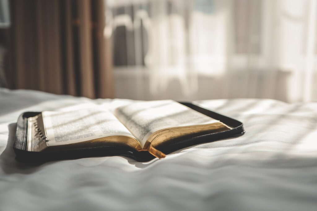 An open book lying on the bed