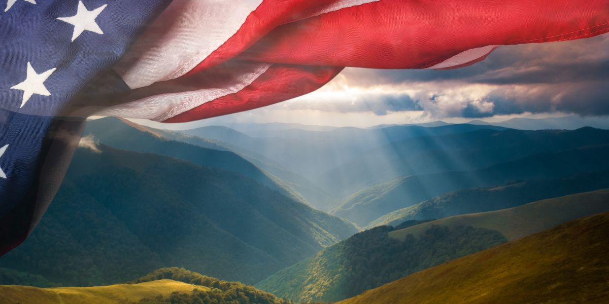 Image of American flag over sweeping landscape