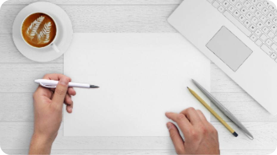 A white sheet of paper and hands intending to write